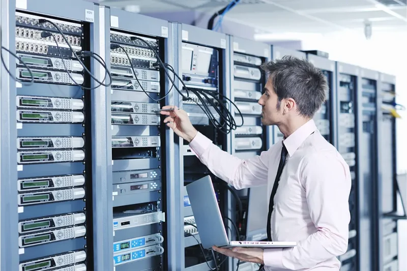 businessman-with-laptop-network-server-room